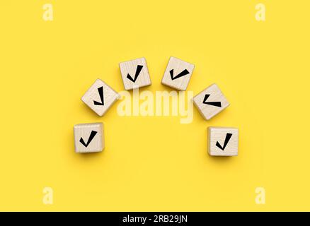Check Mark Cube Cubes with check marks on yellow background, top view Stock Photo - Alamy