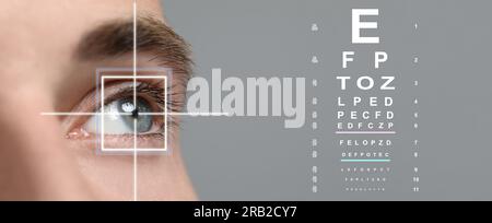 Vision test chart and laser reticle focused on man's eye against light grey background, closeup. Banner design Stock Photo