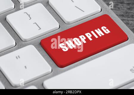 Online store purchase. Red button with word Shopping on computer keyboard, closeup Stock Photo