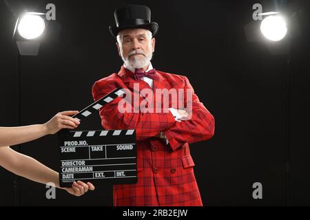 Senior actor performing role while second assistant camera holding ...