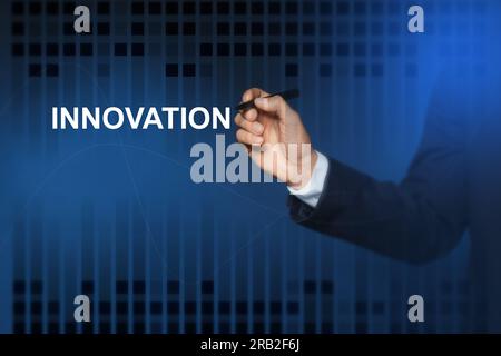 Man touching word Innovation on digital screen against blue background, closeup Stock Photo