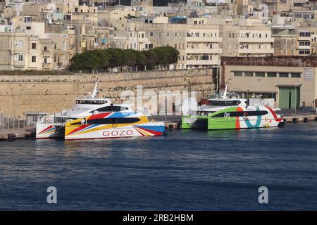 “Gozo Express” and “Your Wisdom” provide a 45 minute fast catermaran ferry service between Valletta, Malta and Mgarr, Gozo, April 2023. Stock Photo