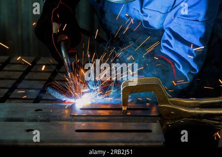 Skilled welder carries out various welding works using semi automatic argon arc welding methods. Stock Photo