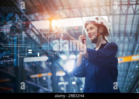 Engineer woman with advanced digital computer technology overlay control touch screen operation monitor industry factory  process happy smiling. Stock Photo