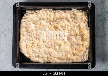 Carrot salad with yogurt on gray background. Salad prepared with yogurt, grated carrots, walnuts, olive oil, grated garlic and salt. healthy appetizer Stock Photo