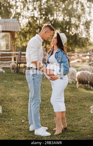 Happy man hugs his pregnant woman's belly at sunset Stock Photo - Alamy