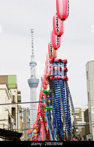 Tokyo, Japan. 7th July, 2023. Tokyo Skytree is seen behind the decorations for the Tanabata festival at Kappabashidogugai Street, the shopping street near Asakusa in Tokyo. Kappabashi-dori, also known just as Kappabashi or Kitchen Town, is a shopping street in Tokyo between Ueno and Asakusa famous for supplying the restaurant industry. The annual celebration commemorates the legend of two lovers separated by the Milky Way who only meet once a year on the seventh day of the seventh month. (Credit Image: © Rodrigo Reyes Marin/ZUMA Press Wire) EDITORIAL USAGE ONLY! Not for Commercial USAGE! Stock Photo