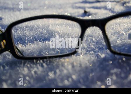 glasses lie on the snow, winter, bright sunny day Stock Photo