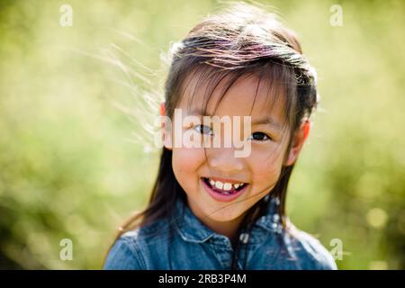 Portrait of Seven Year Old Asian Girl in Field in San Diego Stock Photo