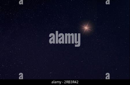 Single bright star in the sky for the holiday with room for copy Stock Photo