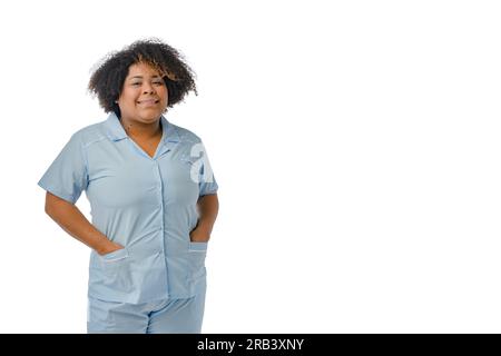 portrait young Afro-Latina doctor woman of Venezuelan ethnicity smiling and looking at the camera, wearing a blue uniform is with her hands in the poc Stock Photo