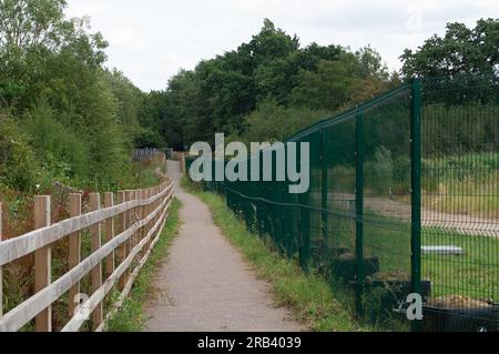Ruislip, UK. 6th July, 2023. Some public footpaths remain open near HS2 sites but are fenced off by tall green security fences. Credit: Maureen McLean/Alamy Live News Stock Photo