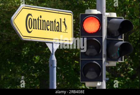 Gifhorn, Germany. 07th July, 2023. A red traffic light shines next to a sign pointing the way to the Continental plant. Automotive supplier Continental plans to close its loss-making plant in Gifhorn by the end of 2027. Credit: Julian Stratenschulte/dpa/Alamy Live News Stock Photo