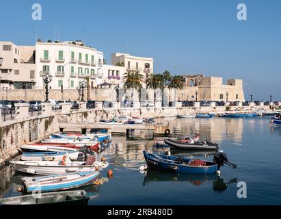 BARI, ITALY - OCTOBER 30, 2021: Harbour with small boats Fortino di Sant Antonio fortress building in Bari Stock Photo