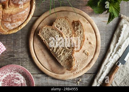 Slices of sourdough bread on a rustic table, top view Stock Photo