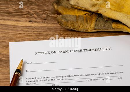 Cash rent farm lease termination letter with work gloves. Farming, agriculture and tenant farming concept. Stock Photo