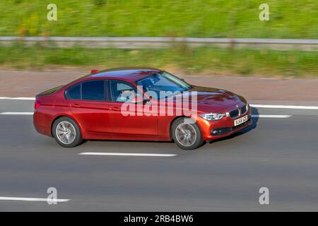 2018 BMW 320D Xdrive Se Auto 320D Xdrive 190 Step Auto Start/Stop Orange Car Saloon Diesel 1995 cc travelling at speed on the M6 motorway in Greater Manchester, UK Stock Photo
