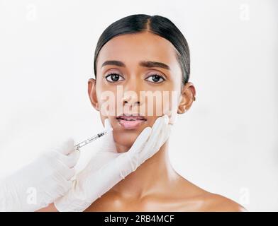 Scared, worry and face of Indian woman on pink background with