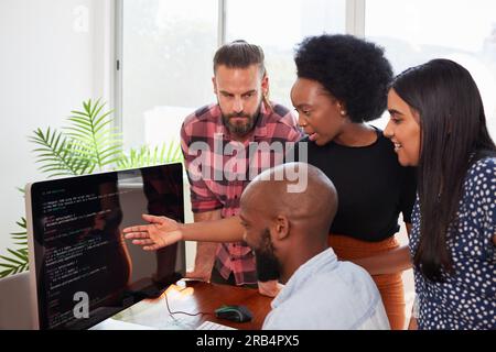 Development team reviews code, product owner, scrum master, developers in office Stock Photo
