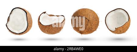 Flying coconut. Halves of coconuts on a white isolated background. Parts of coconuts with a crust cast a shadow close-up. Stock Photo