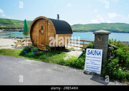 Pop-up mobile sauna for tourists near the beach at Ballydonegan, Allihies, County Cork, Ireland - John Gollop Stock Photo