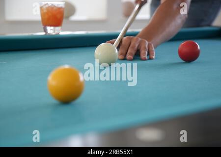 Playing billiard - Close-up shot of a man playing table pool game Stock Photo