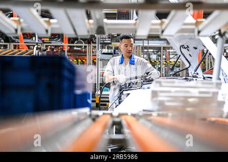 Changchun, China. 07th July, 2023. (230707) -- CHANGCHUN, July 7, 2023 (Xinhua) -- This photo taken on June 12, 2023 shows a worker assembling vehicles at the general assembly line of FAW-Volkswagen in Changchun, northeast China's Jilin Province. Founded in 1953 in Changchun, First Automotive Works (FAW) Group Corporation is dubbed the cradle of China's auto industry. As one of China's leading automakers, FAW Group Corporation will celebrate its 70th anniversary of establishment on July 15, 2023. (Xinhua/Yan Linyun) Credit: Xinhua/Alamy Live News Stock Photo