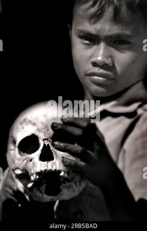 Young Man with Skull. Asia Stock Photo
