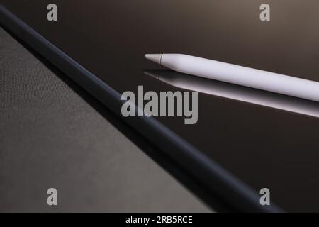 Close-up of digital tablet and pencil on black background Stock Photo