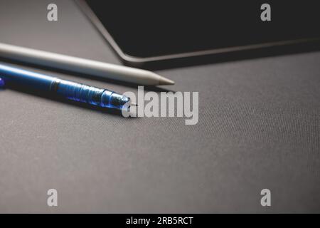 Pencil and tablet on black background. Close-up view. Stock Photo