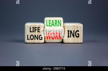 Lifelong learning working symbol. Concept word Lifelong learning working on block on a beautiful grey table grey background. Business educational life Stock Photo