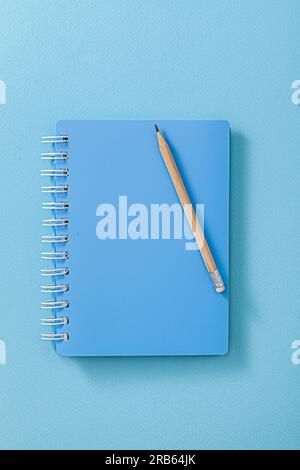 Blue Notepad With Wooden Pencil Close Up Stock Photo
