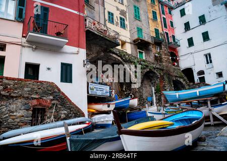 Small boats and stone arches in Riomaggiore, a fishing and grape growing village, Cinque Terre, Italy. Stock Photo