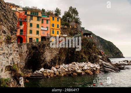 Colorful tower houses, kayaks and stone stairways in Riomaggiore, a fishing and grape growing village in Cinque Terre, Italy. Stock Photo