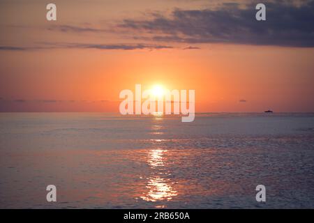 Beautiful evening landscape with sunset over the sea water surface. Stock Photo