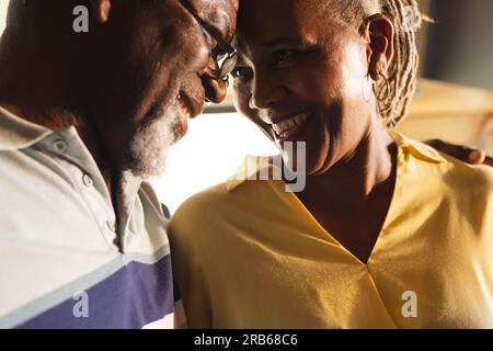 Happy senior african american couple embracing and talking at home. Senior lifestyle, relaxing and retirement, unaltered. Stock Photo