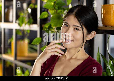 Portrait of happy, relaxed asian casual businesswoman smiling in office. Work, business, confidence, wellbeing and casual office, unaltered. Stock Photo
