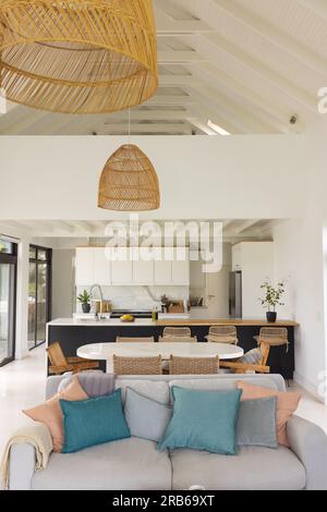 General view of empty living room with couch and kitchen at window. House interior and design. Stock Photo