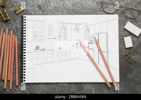 Sketch of cityscape in notebook, glasses, pencils and other stationery on grey table, flat lay Stock Photo
