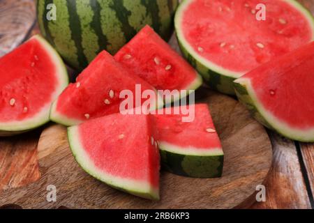 Pieces of juicy ripe watermelons on wooden table, closeup Stock Photo