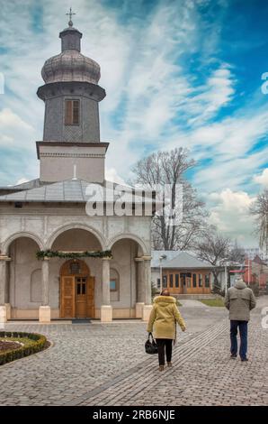 couple walking in the paved yard of an orthodox church in the middle of the city Stock Photo