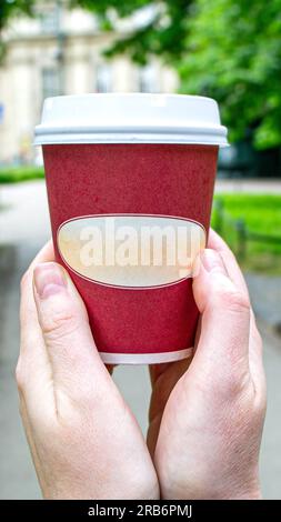 Coffee Business Concept-Female barista making coffee and serving a paper cup of hot coffee in street. High quality photo Stock Photo