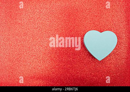 Christmas high view gift boxes clustered on red background. Gifts are scattered along the edge of the frame. Leave a blank space in the middle for you Stock Photo