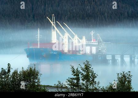 Tanker in the mist with pine trees forest, Stewart, British Columbia, Canada. Stock Photo