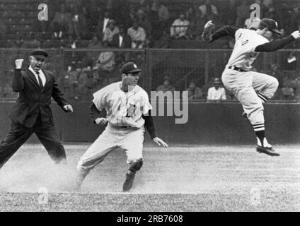 Detroit, Michigan:  c. 1961 Detroit's Rocky Colavito  is called out at second by umpire Sam Carrigan as Chicago White Sox shortstop Luis Aparicio leaps out of the way after stepping on second base. Stock Photo