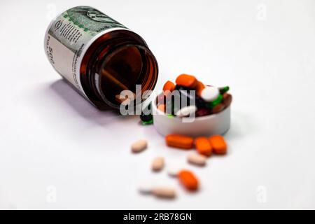 This stock photo shows an Indian 500 rupee note covered up with a bottle and pills on the cap and floor. The photo is well-lit and the subject is in f Stock Photo
