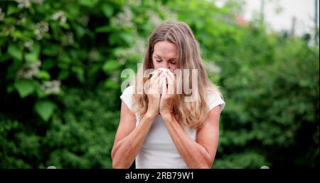 Allergic Nose And Pollen Allergy. Sneezing Into Handkerchief Stock Photo