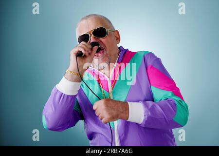 Rich Man In Disco Club Singing. Gold Chain Stock Photo