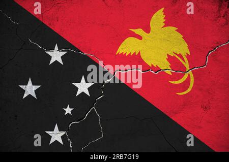 An image of the Papua New Guinea flag on a wall with a crack. Background. Stock Photo