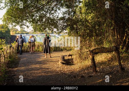 VICTORIA FALLS, ZIMBABWE - JUNE 17th, 2023: Tourists looking at the Cataract Island View at the Victoria Falls Stock Photo